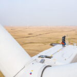 Orsted-employee-on-top-of-turbine