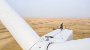 Orsted-employee-on-top-of-turbine