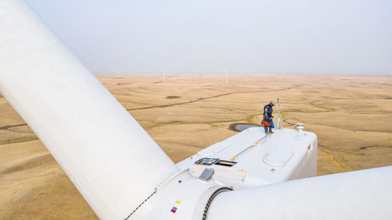 Orsted-employee-on-top-of-turbine